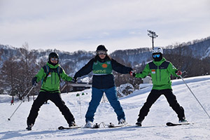 Byamba-san holding hands with the instructors during the ski training program.