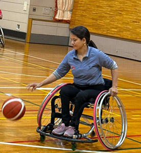 Laxmi-san playing wheelchair basketball.